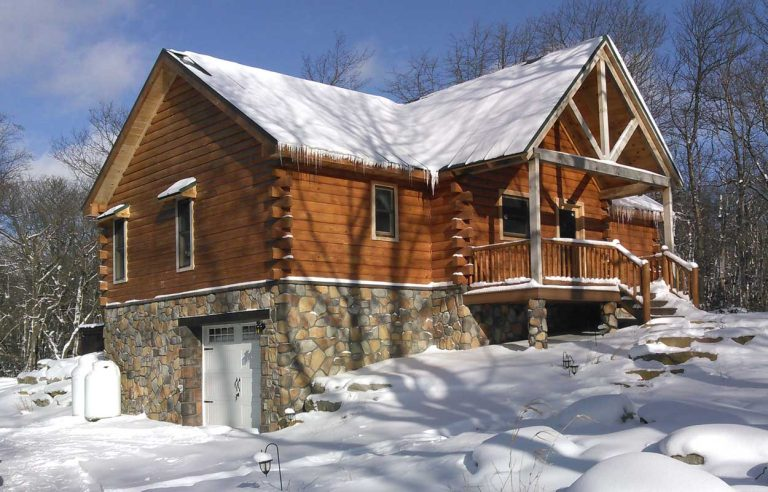 Beautiful log cabin in the winter time snow
