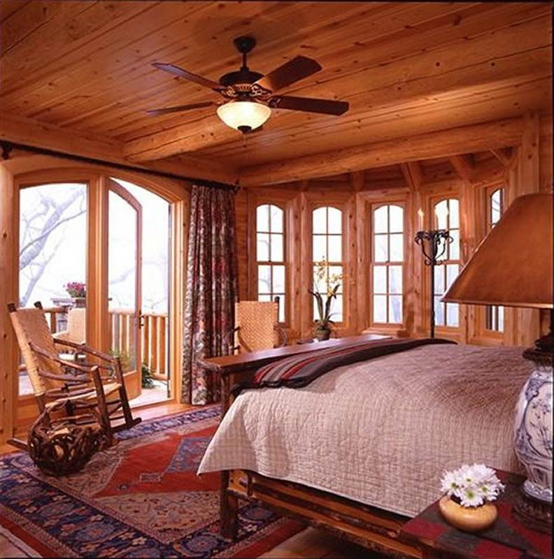 Beautiful log home master bedroom with balcony